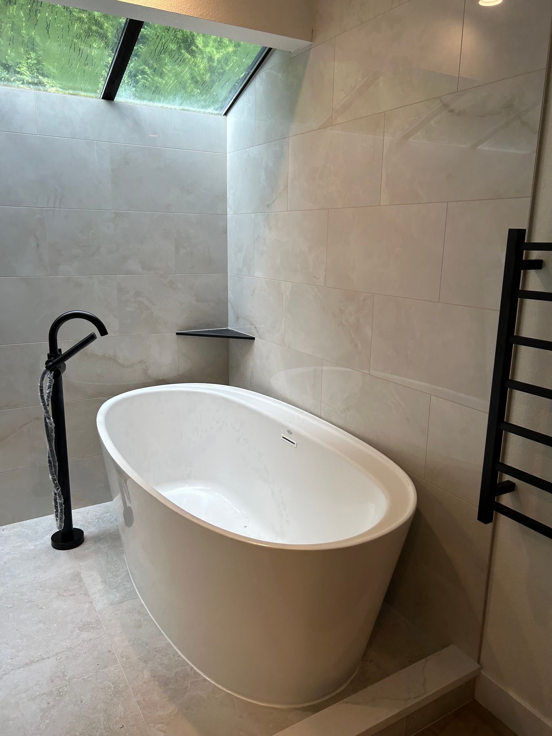 Freestanding bathtub and floor-mounted faucet installed by Royal Flush Freestanding bathtub and floor-mounted faucet installed by Royal Flush