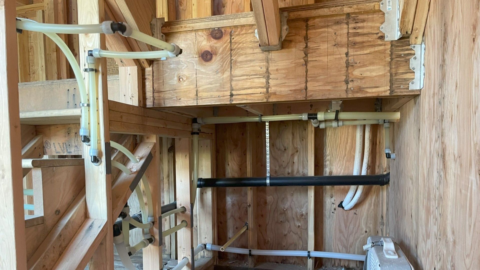 A room with a lot of pipes hanging from the ceiling