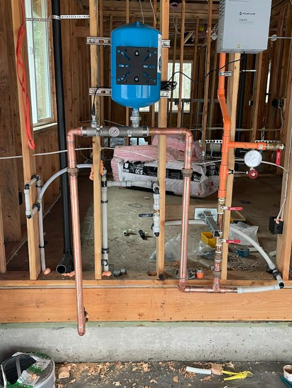 A plumbing system is being installed in a house under construction by royal flush plumbing in tacoma.