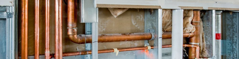 Copper rough-in pipework installed against a framed wall Copper rough-in pipework installed against a framed wall