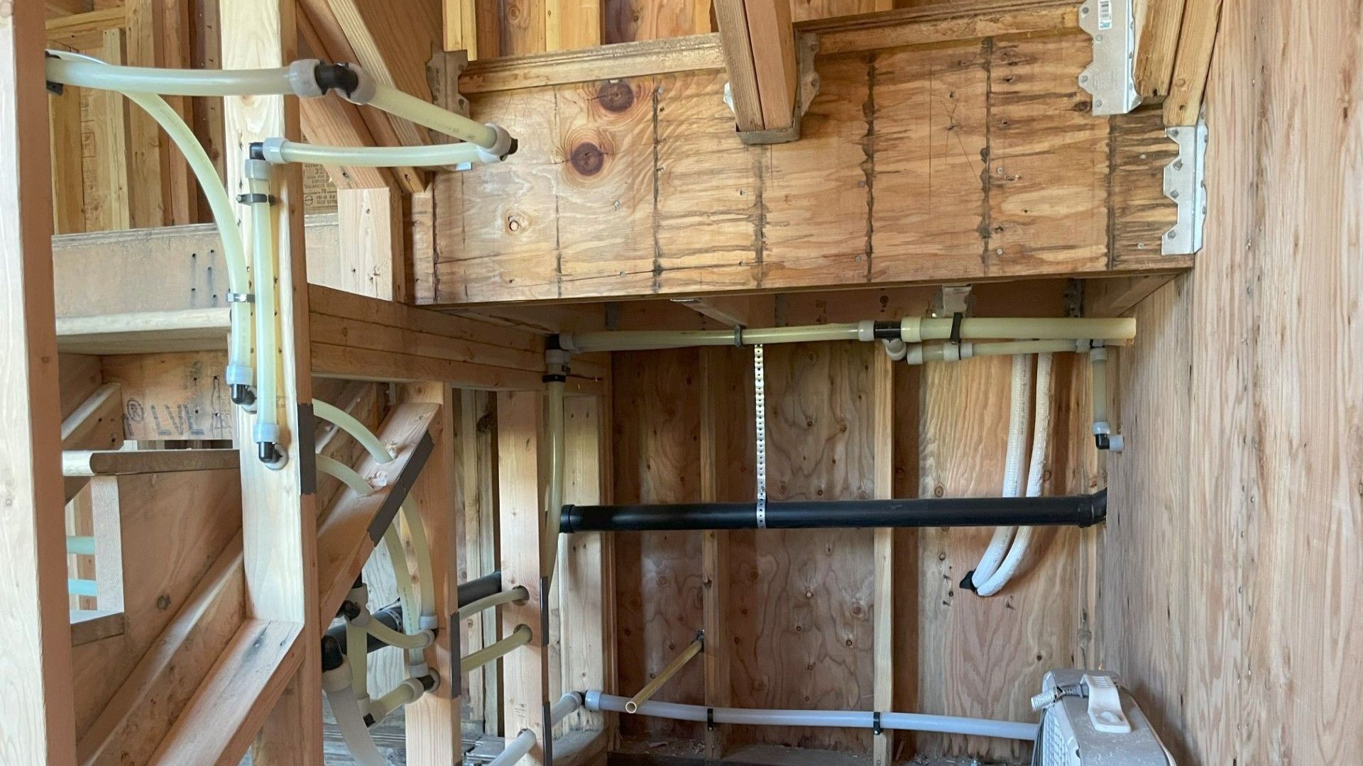 A room with a lot of pipes hanging from the ceiling